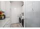 Laundry room equipped with modern washer and dryer, storage cabinets, countertop, and plenty of workspace at 6941 W Voltaire Ave, Peoria, AZ 85381