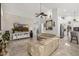 Open-concept living room with a ceiling fan, tile floors, and a large TV for relaxing and entertainment at 6941 W Voltaire Ave, Peoria, AZ 85381