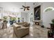 Spacious living room with a fireplace, ceiling fan, and access to a dining area at 6941 W Voltaire Ave, Peoria, AZ 85381