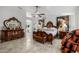 Expansive main bedroom with tiled flooring, ornate furnishings, and access to the en-suite bathroom at 6941 W Voltaire Ave, Peoria, AZ 85381