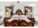 Close-up of the main bedroom featuring an ornate bed, large headboard, and decorative pillows and artwork at 6941 W Voltaire Ave, Peoria, AZ 85381