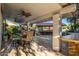 Outdoor patio with a built-in bar, ceiling fans, and comfortable seating, great for entertaining at 6941 W Voltaire Ave, Peoria, AZ 85381
