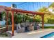 Inviting outdoor lounge area with a cozy fire pit and comfortable seating, perfect for backyard relaxation at 6941 W Voltaire Ave, Peoria, AZ 85381