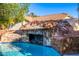 Unique rock waterfall feature cascading into the pool, creating a tranquil and natural oasis at 6941 W Voltaire Ave, Peoria, AZ 85381