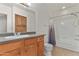 Bathroom with wood cabinets, granite counters, and tile floors at 750 E Northern Ave # 2045, Phoenix, AZ 85020