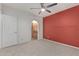 Spacious bedroom featuring neutral carpet, ceiling fan, and doorway to the ensuite bathroom at 750 E Northern Ave # 2045, Phoenix, AZ 85020