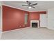 Spacious living room featuring a fireplace, neutral carpet, and ceiling fan at 750 E Northern Ave # 2045, Phoenix, AZ 85020