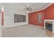 Bright living room with neutral carpet, ceiling fan, and fireplace at 750 E Northern Ave # 2045, Phoenix, AZ 85020