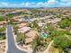 Aerial view of homes, pools, and desert landscaping in a scenic suburban neighborhood on a bright, sunny day at 7734 E Monica Dr, Scottsdale, AZ 85255