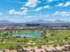 Panoramic aerial view showcasing the golf course and picturesque mountain views in the distance at 7734 E Monica Dr, Scottsdale, AZ 85255