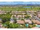 Aerial view of the community featuring well-manicured lawns, mature trees, and a nearby golf course at 7734 E Monica Dr, Scottsdale, AZ 85255