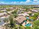 An aerial view shows a home and pool, surrounded by mature trees and desert landscaping in a suburban neighborhood at 7734 E Monica Dr, Scottsdale, AZ 85255
