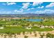 Expansive aerial view of a golf course, blue pond and scenic community at 7734 E Monica Dr, Scottsdale, AZ 85255