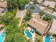 An aerial view features a home with a private pool, mature landscaping, and a circular driveway in a desert neighborhood at 7734 E Monica Dr, Scottsdale, AZ 85255