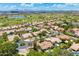 Beautiful aerial view of a desert community with lush landscaping, tile roofs, and community golf course at 7734 E Monica Dr, Scottsdale, AZ 85255