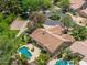 Stunning aerial view of the home showcasing the backyard pool, tile roof, and mature trees at 7734 E Monica Dr, Scottsdale, AZ 85255