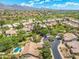 A wide shot shows homes, landscaping, a golf course, and mountain views under a bright blue sky with clouds at 7734 E Monica Dr, Scottsdale, AZ 85255