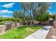 Private backyard featuring a built-in grill area, lush lawn, and mature landscaping at 7734 E Monica Dr, Scottsdale, AZ 85255