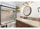 Bright bathroom featuring a shower, toilet, and vanity with custom wood cabinets and granite countertops at 7734 E Monica Dr, Scottsdale, AZ 85255