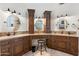 Spacious bathroom featuring dual sinks and vanities with wood cabinets and granite countertops at 7734 E Monica Dr, Scottsdale, AZ 85255