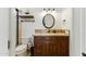 Bathroom showcasing travertine floors, a dark wood vanity, and neutral tiling in the shower-tub at 7734 E Monica Dr, Scottsdale, AZ 85255