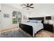 The main bedroom features a large window with a window seat, modern light fixture, and night stands at 7734 E Monica Dr, Scottsdale, AZ 85255