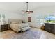Bedroom with a ceiling fan, shuttered windows, neutral decor, and an area rug at 7734 E Monica Dr, Scottsdale, AZ 85255