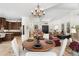Open concept dining area with wood table, chandelier, and views into the living room and kitchen at 7734 E Monica Dr, Scottsdale, AZ 85255