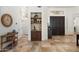 Inviting entryway featuring dark wood double doors, tile flooring, and a stylish wet bar niche at 7734 E Monica Dr, Scottsdale, AZ 85255
