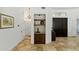 Elegant entryway featuring a built-in bar area, shelving, and tile flooring, showcasing a warm welcome at 7734 E Monica Dr, Scottsdale, AZ 85255