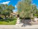 Beautiful home with lush landscaping, mature trees, and a welcoming entrance, showcasing curb appeal at 7734 E Monica Dr, Scottsdale, AZ 85255
