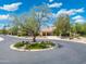 Charming home showcasing a well-manicured front yard and circular driveway with mature trees and landscaping at 7734 E Monica Dr, Scottsdale, AZ 85255