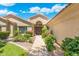 Inviting home exterior boasting manicured landscaping and a beautiful walkway to the arched double-door entrance at 7734 E Monica Dr, Scottsdale, AZ 85255