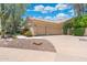 A three car garage with beautiful desert landscaping including a beautiful Saguaro cactus at 7734 E Monica Dr, Scottsdale, AZ 85255