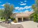 Spacious home with a three-car garage, tile roof, desert landscaping, and ample parking space at 7734 E Monica Dr, Scottsdale, AZ 85255