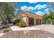 Spacious three-car garage featuring ample parking and storage space, complemented by desert landscaping at 7734 E Monica Dr, Scottsdale, AZ 85255