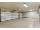 Spacious two-car garage with epoxy flooring, ideal for storage and vehicles at 7734 E Monica Dr, Scottsdale, AZ 85255