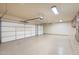 Spacious three car garage with painted floors and storage cabinets at 7734 E Monica Dr, Scottsdale, AZ 85255