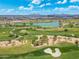 Picturesque golf course featuring a serene lake, sand traps, and meticulously manicured greens against a beautiful sky at 7734 E Monica Dr, Scottsdale, AZ 85255