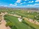 Well-maintained golf course with lush greenery, sand traps, and a picturesque backdrop of mountains under a bright sky at 7734 E Monica Dr, Scottsdale, AZ 85255