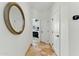 Hallway featuring travertine floors, a decorative oval mirror, and doorway view into the bedroom at 7734 E Monica Dr, Scottsdale, AZ 85255
