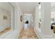 Hallway boasting travertine floors, white walls, and views into the living room and bedroom at 7734 E Monica Dr, Scottsdale, AZ 85255