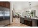 Bright open kitchen with stainless steel appliances and a view of the dining area and living room at 7734 E Monica Dr, Scottsdale, AZ 85255