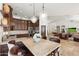 Spacious kitchen with granite island, pendant lights, custom cabinets, and an open flow to the living room at 7734 E Monica Dr, Scottsdale, AZ 85255