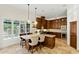 Gourmet kitchen island with seating, custom cabinetry, pendant lights, and views of the backyard at 7734 E Monica Dr, Scottsdale, AZ 85255