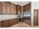 The kitchen features custom cabinets, stainless steel appliances, and under counter wine cooler at 7734 E Monica Dr, Scottsdale, AZ 85255