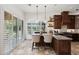 Beautiful kitchen with dark wood cabinets, stone countertops, pendant lighting, and shuttered windows at 7734 E Monica Dr, Scottsdale, AZ 85255