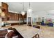 Kitchen with granite countertops, custom wood cabinets, island seating, and stainless steel appliances at 7734 E Monica Dr, Scottsdale, AZ 85255