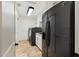 This roomy laundry has stainless steel appliances, white cabinets, granite countertops and travertine tile at 7734 E Monica Dr, Scottsdale, AZ 85255