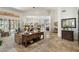Open-concept living room featuring tile floors, neutral decor, and large windows that flood the space with natural light at 7734 E Monica Dr, Scottsdale, AZ 85255